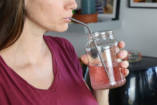 a woman drinking using a Reusable straw made in stainless steel 