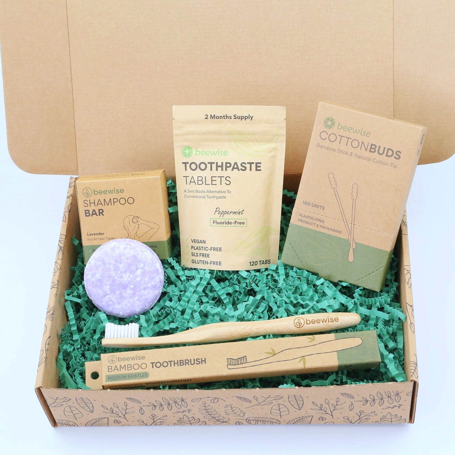 A sustainable eco gift box with shampoo bar, toothbrush, toothpaste tablets and bamboo cotton buds for a plastic-free bathroom routine