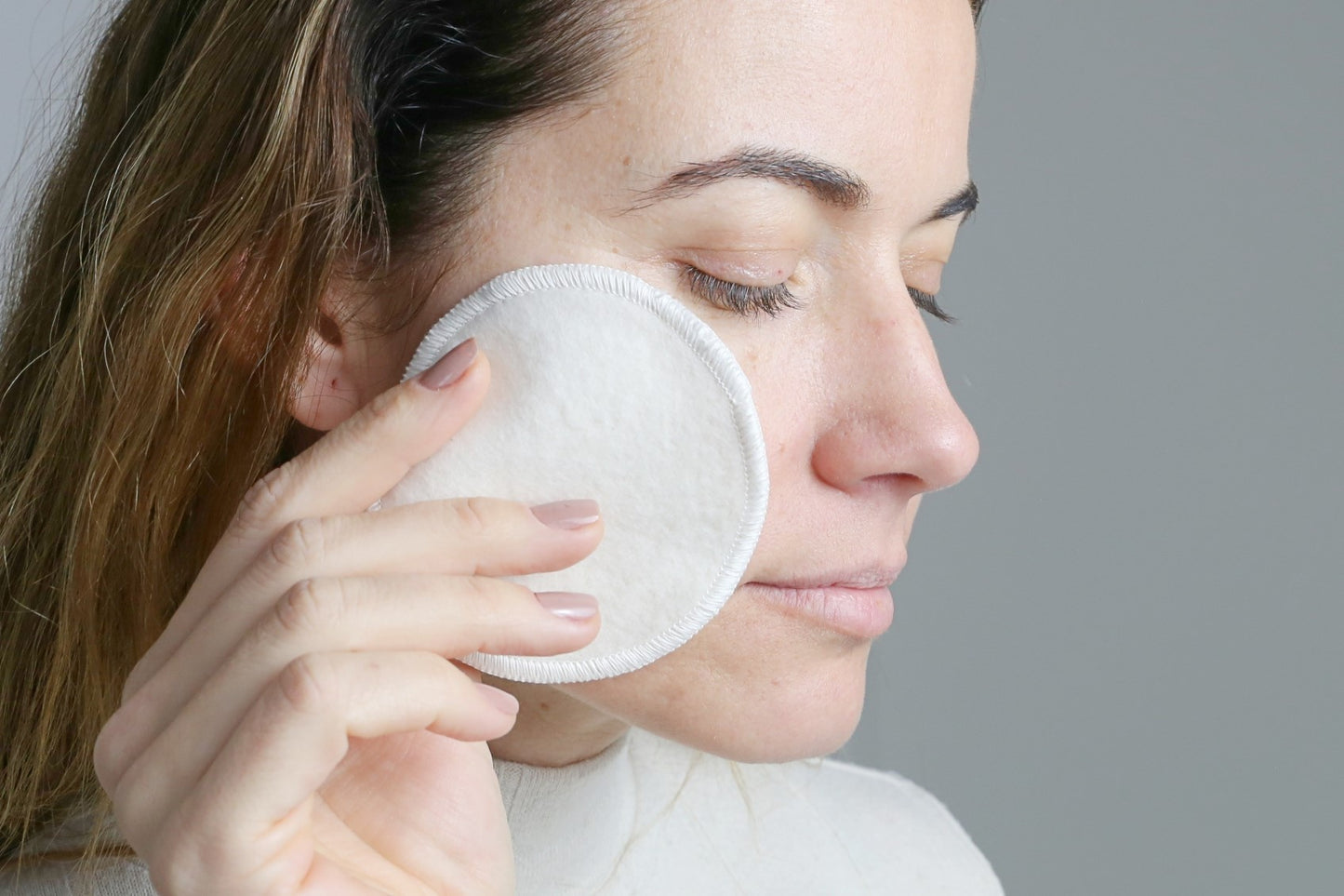 Reusable Makeup Remover Pads showing removing the makeup pads from a woman face