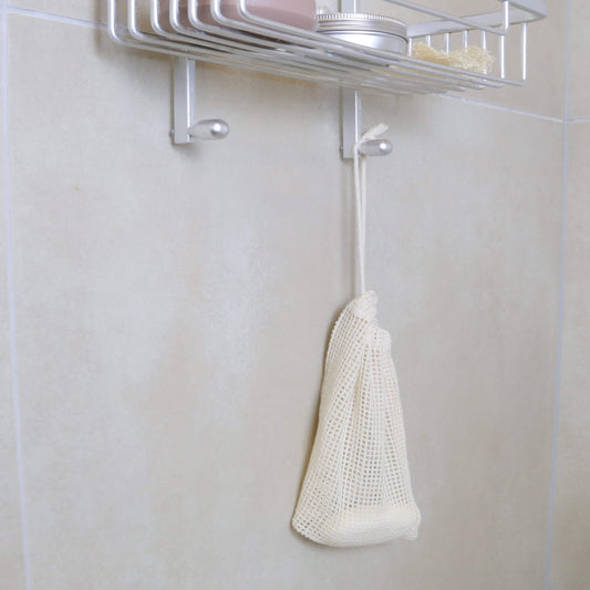 Small organic cotton mesh bag ideal for soap leftover pieces, makeup pads, and socks – perfect for sustainable storage hanging in the shower with soap inside