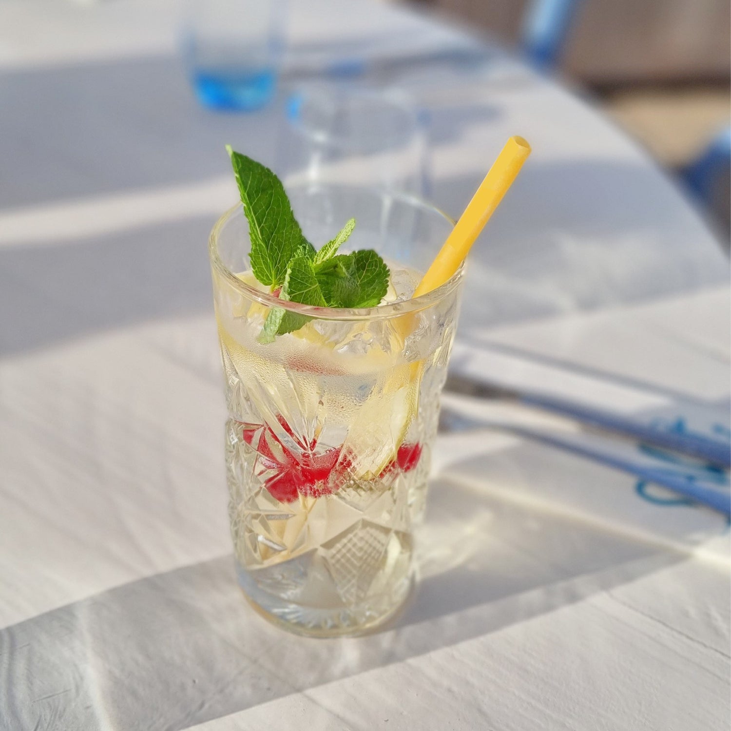 pasta straws inside a cocktail with mint and strawberries
