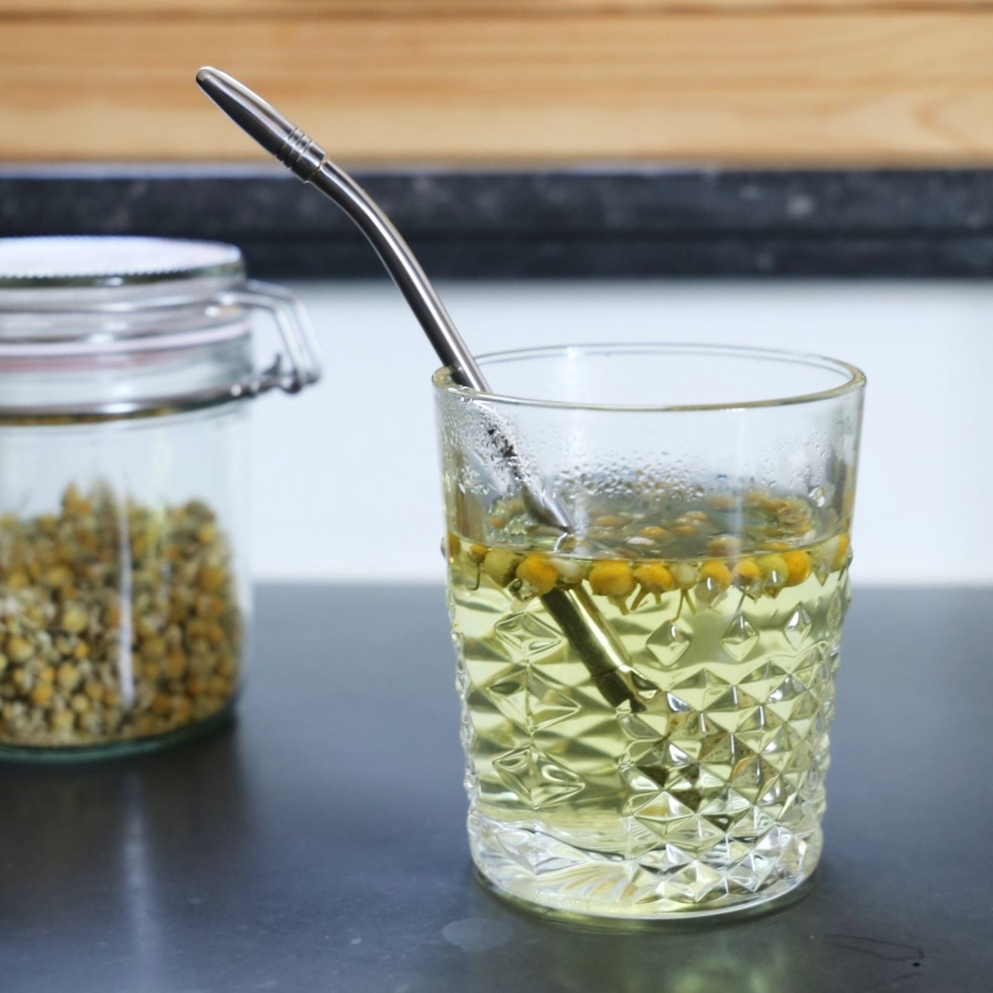 tea straw and strainer made of stainless steel being use for a tea