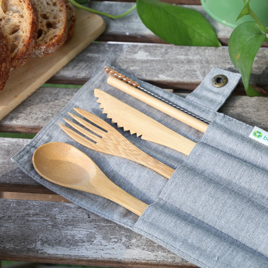 bamboo cutlery set in a cotton travel pouch on top of a table