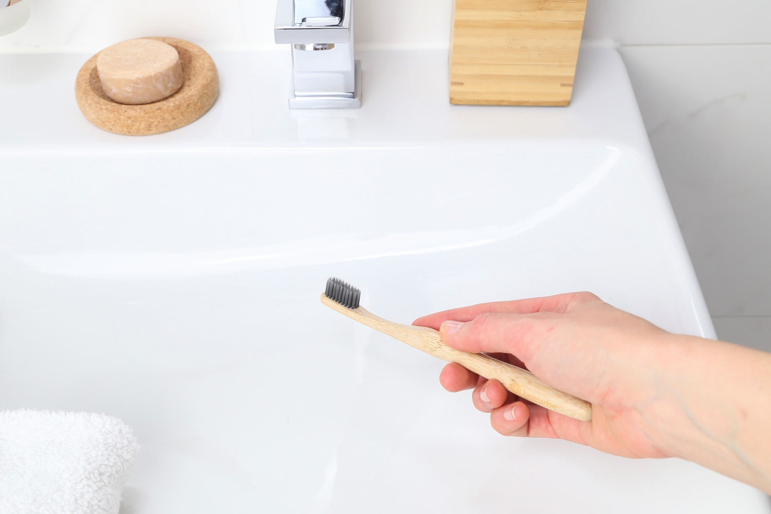 bamboo toothbrushes for adults from Beewise soft charcoal bristles being used in the sink