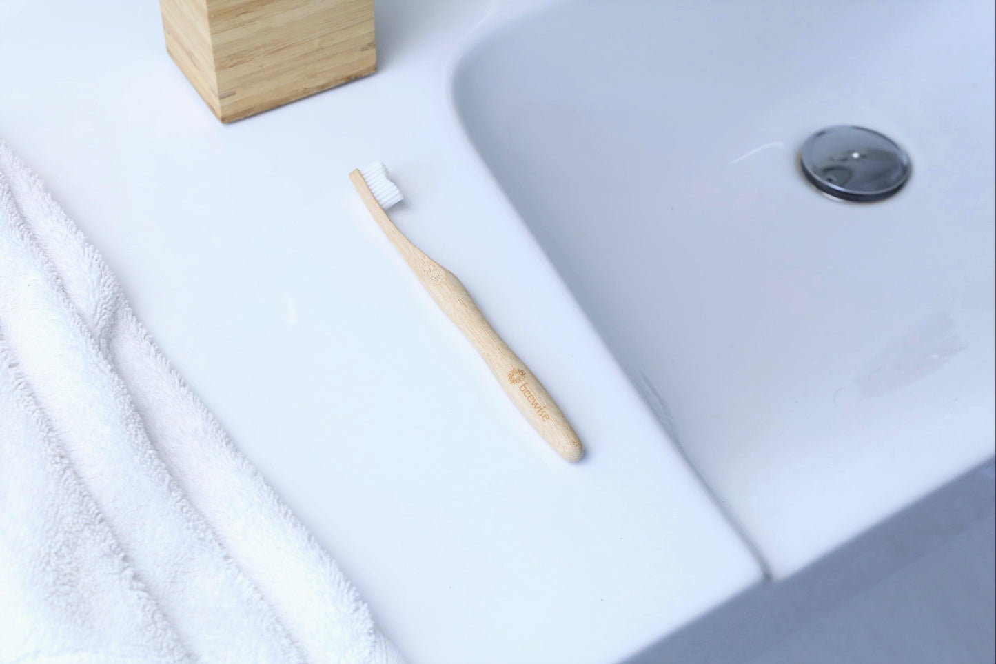 bamboo toothbrush for adults from beewise medium bristles on the top of a towel