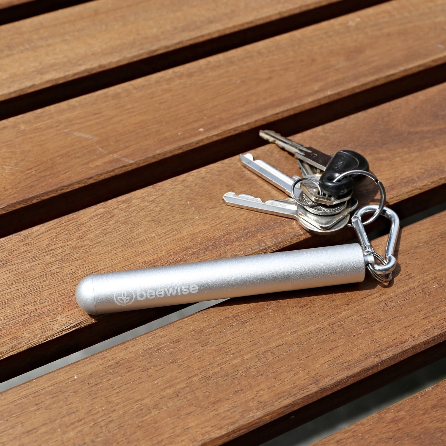 reusable straw collapsible silver case and silver colour being used attached to a keychain