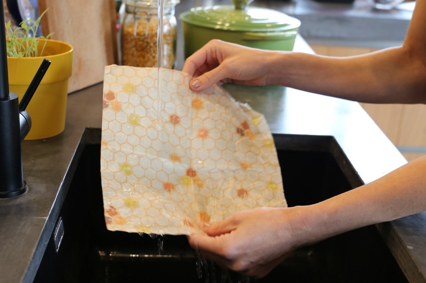 beeswax food wrap hive pattern from beewise amsterdam being washed with water and a mild soap