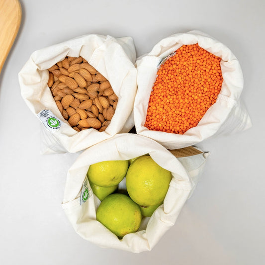 reusable produce bag made with organic cotton showing lentils, lemons and nuts being packed plastic-free