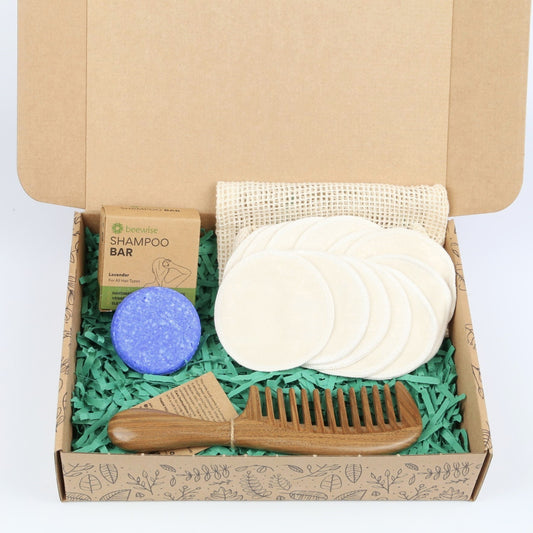 eco gift box with sustainable products with shampoo bar reusable makeup pads remover and wood comb