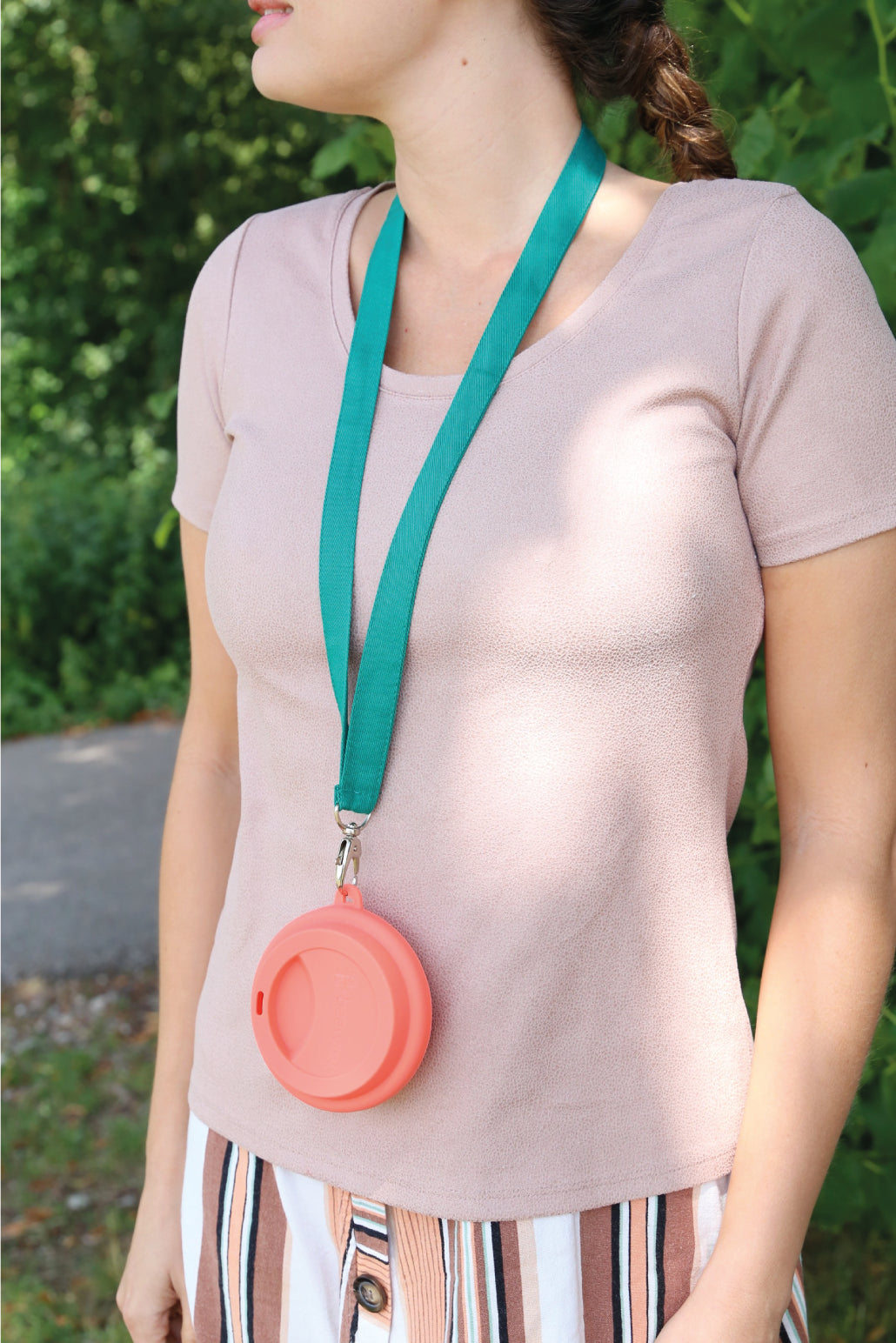 cup holder necklace being showed with a reusable silicone cup on neck of a woman