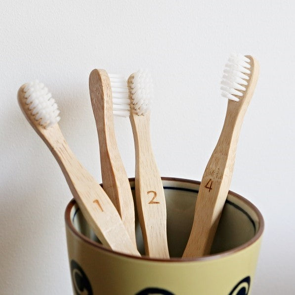 four bamboo toothbrush for kids from beewise with numbers from 1 to 4