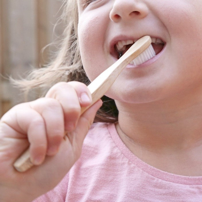 a child using a bamboo toothbrush from beewise amsterdam