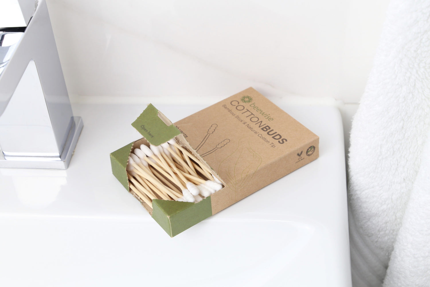 bamboo cotton buds home compostable in a kraft paper packaging from beewise on top of the bathroom sink