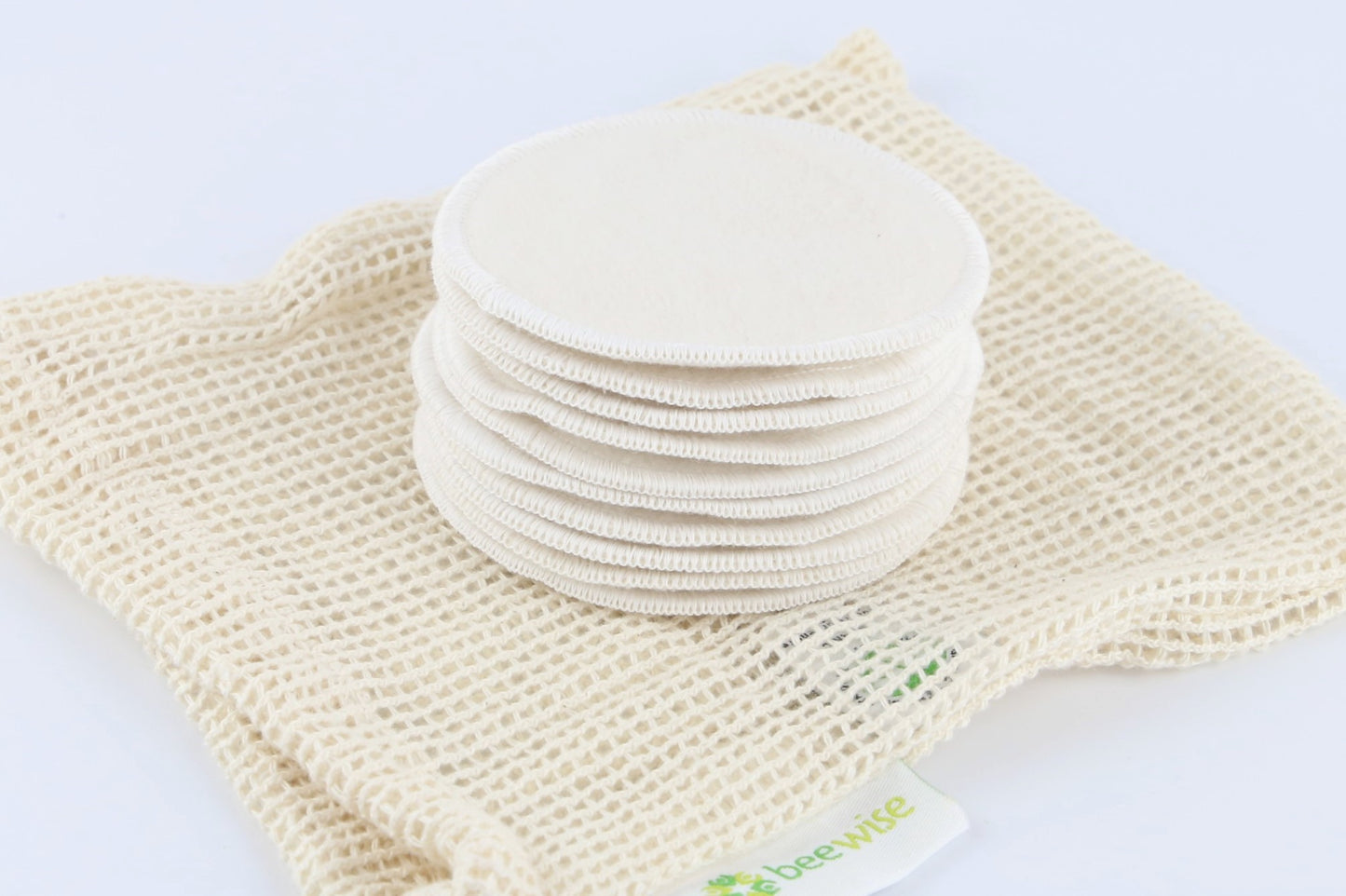 Reusable Makeup Remover Pads made of organic cotton showing on top of the mesh bag