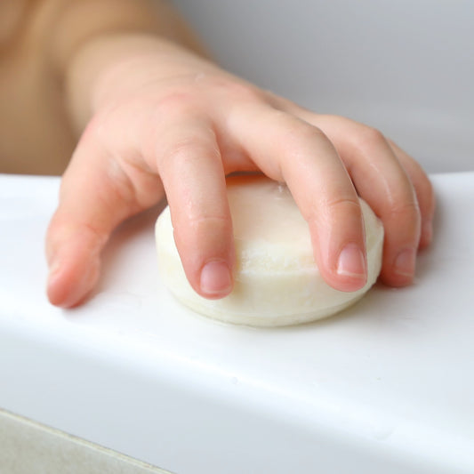 sustainable and zero waste shampoo bar for baby and kids with a child taking it in his hands